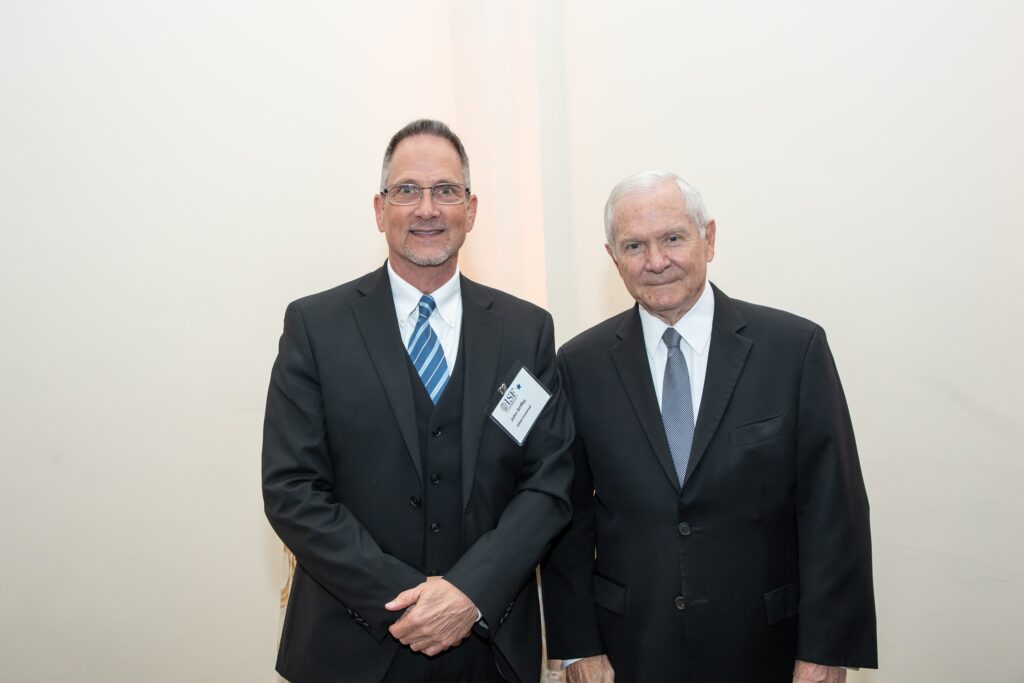 two men in suits and ties standing next to each other