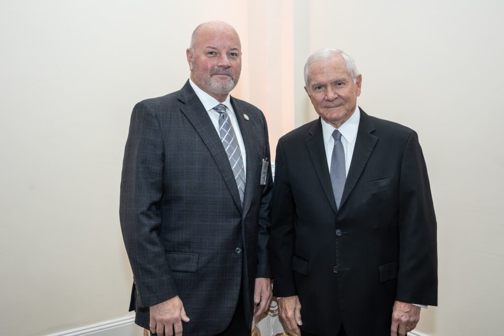 two men in suits standing next to each other